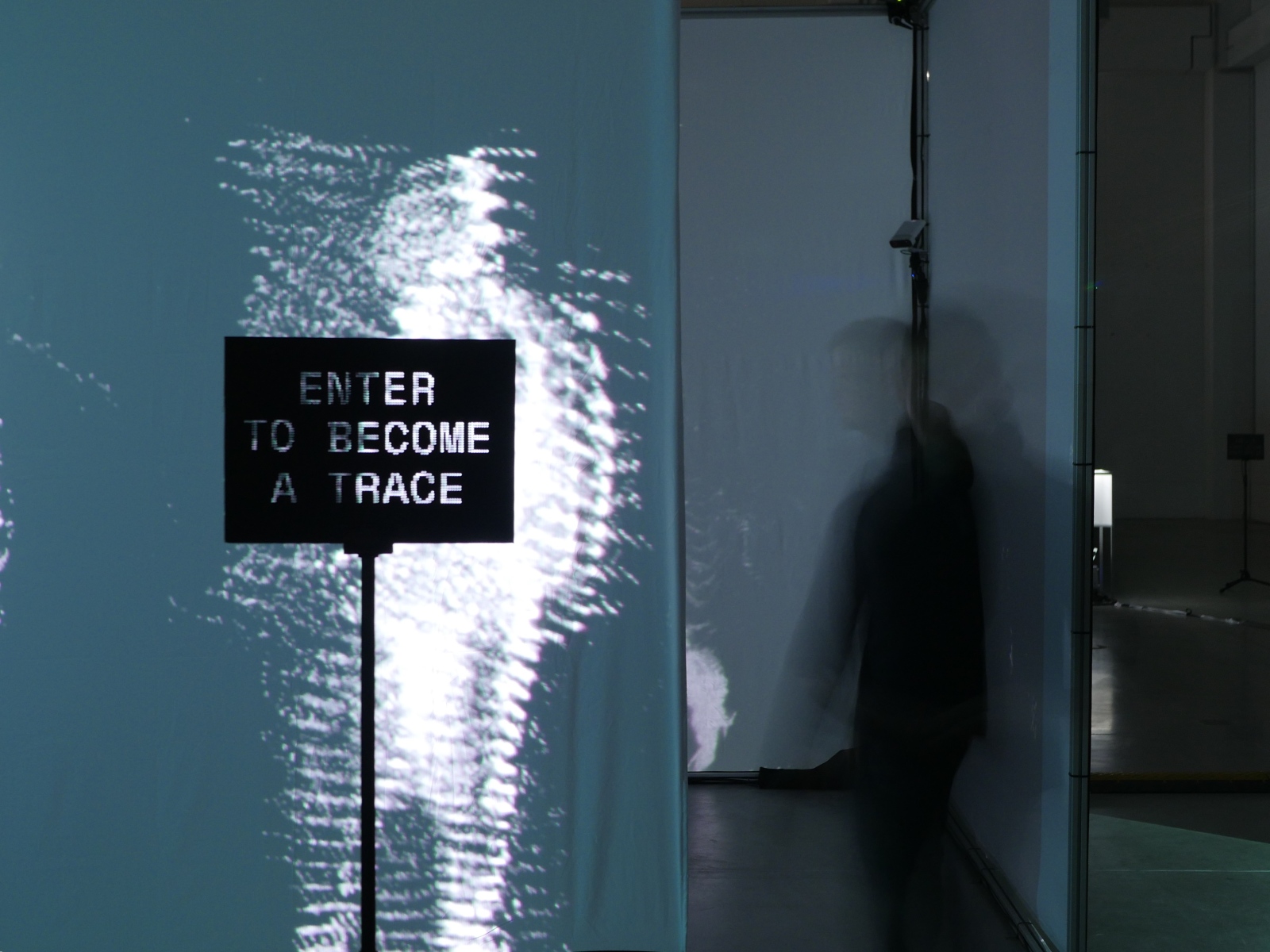 Perforated card used as an in-space textual label: ENTER TO BECOME A TRACE. Photo: Viacheslav (Slava) Romanov.